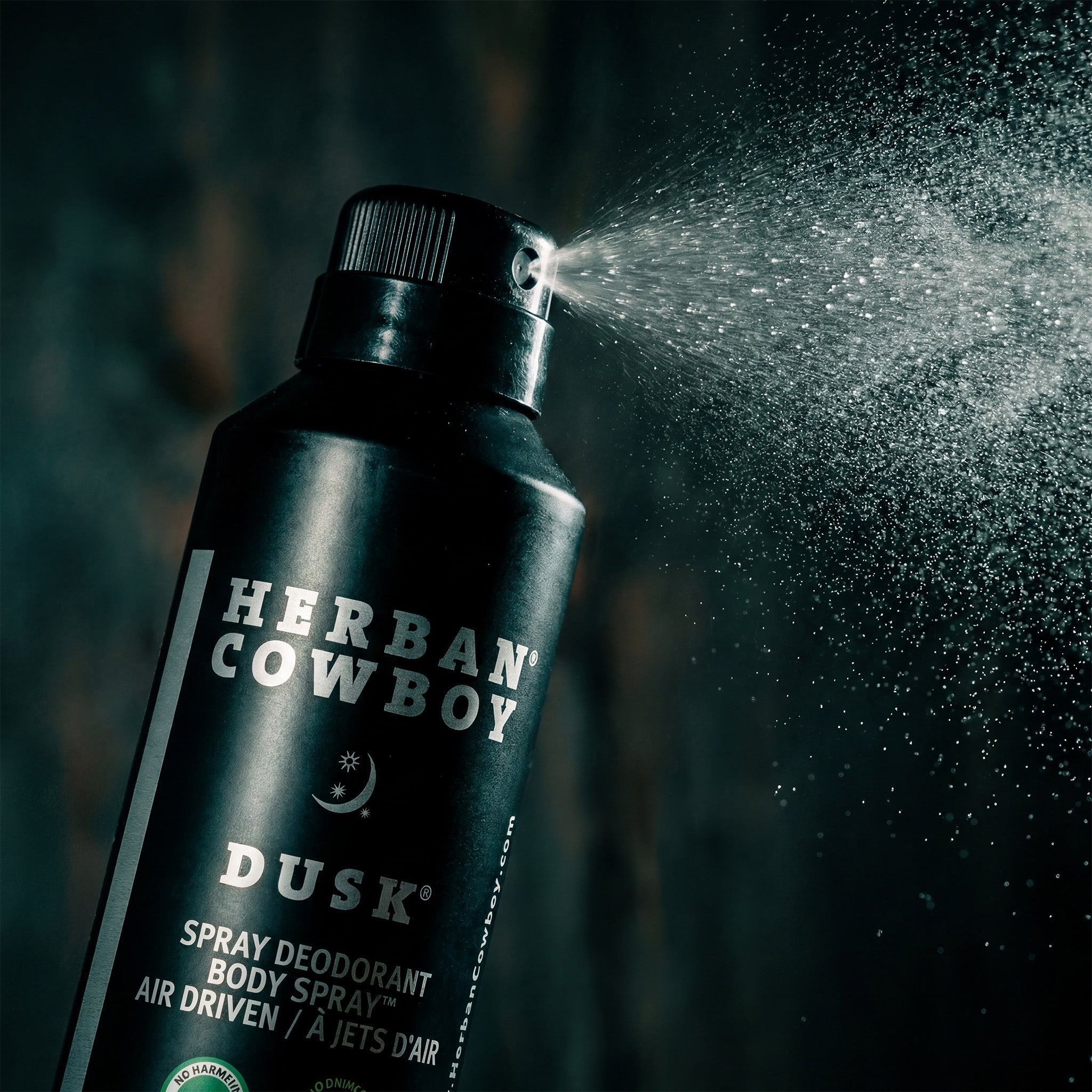 Herban Cowboy Dusk spray deodorant being sprayed