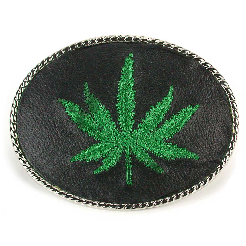 An embroidered belt buckle featuring a green cannabis leaf on a black background with a silver rope border.