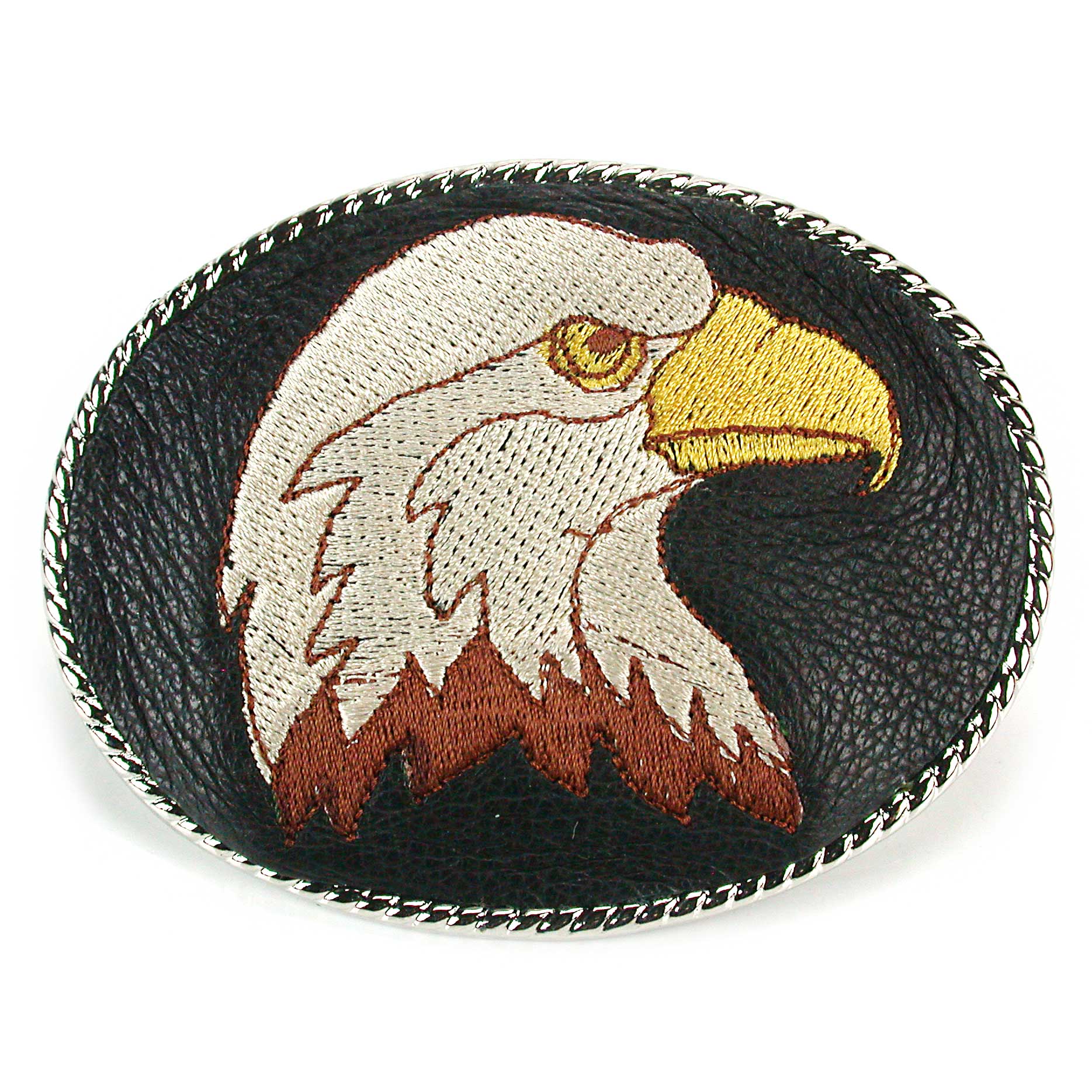 An embroidered belt buckle featuring a brown eagle head design on a black leather background with silver rope trim.