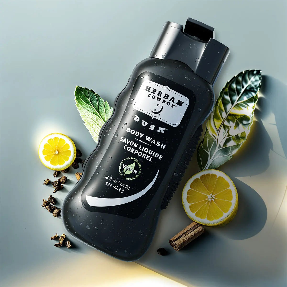 Herban Cowboy Dusk body wash bottle with lemon slices and leaves